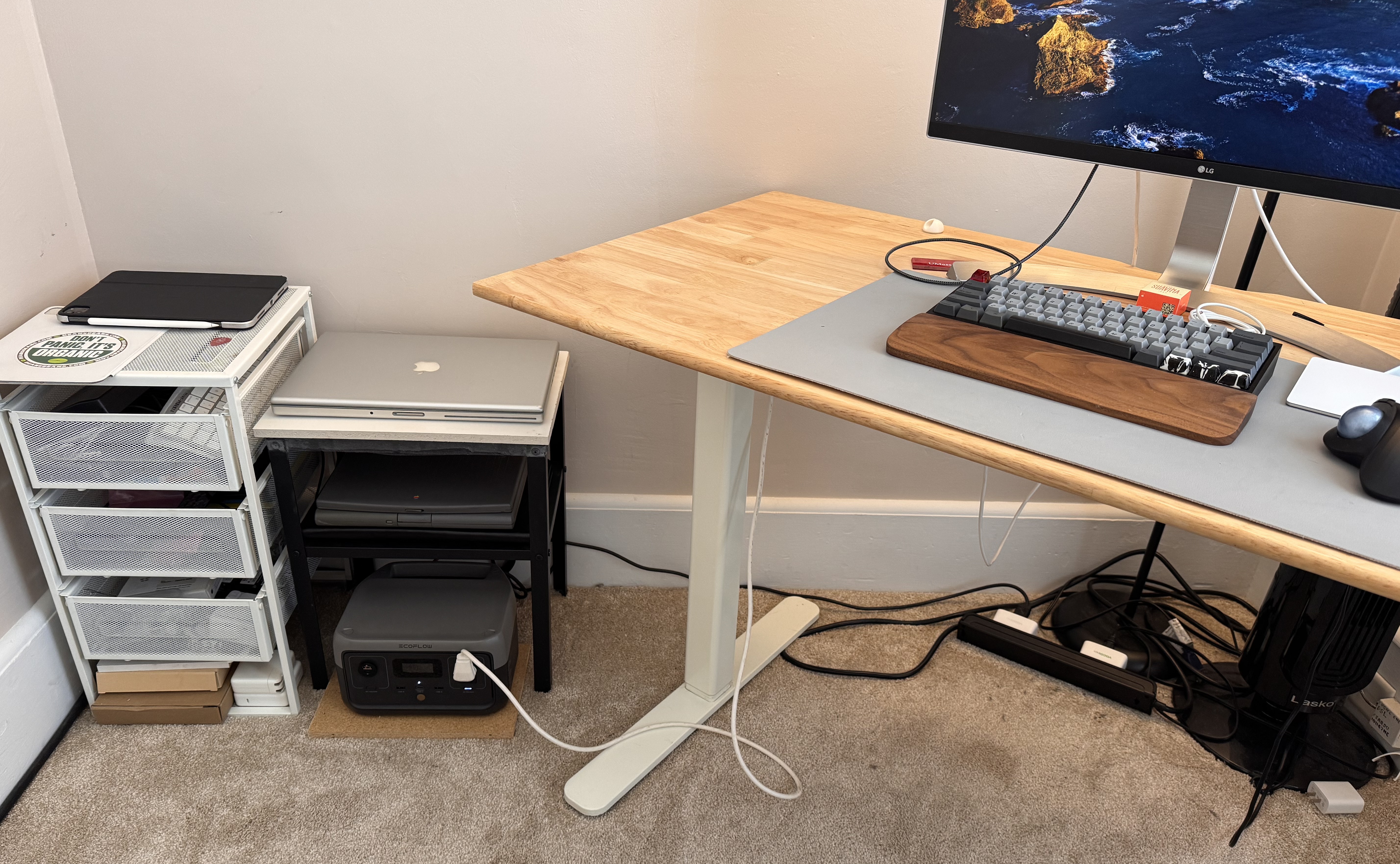 Picture of my home office, showing my desk and adjacent area, where the RIVER 2 power station is plugged into both solar and AC inputs under a small table.